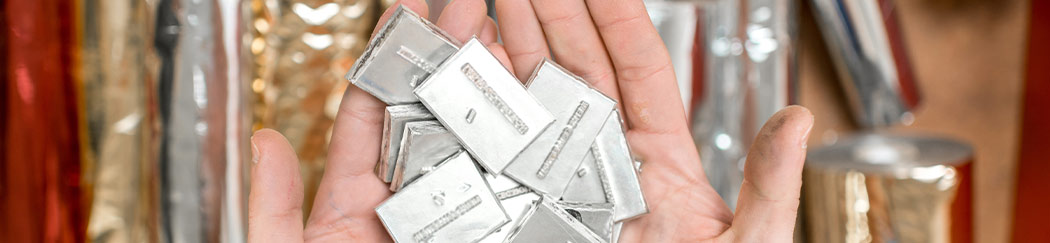 Hands Holding Metal Stamping Plates